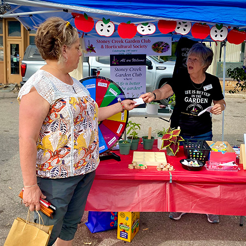 Juanita buying ticket at market during apple Fest