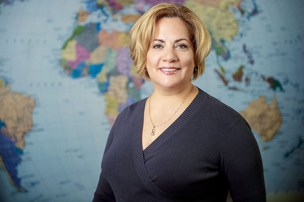Juanita Maldonado infrount of world map
